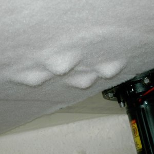 (Lynn Marie) arpet layed over nut/bolt ends and winch backing plate just above rope locker bulkhead. Carpet stretches well over small lumps.