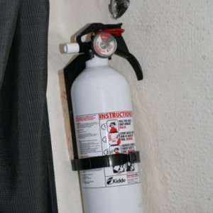 2nd fire extinguisher added to port bulk head inside the berth - screwed to piece of oak glued with 5200.