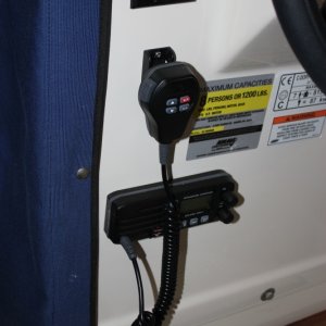 Media 'Radio installed in the helm.' in album 'I used a tire air valve to get the antenna cable through the roof.  It is a snug fit; hopefully water will stay outside of the cabin.'