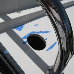 The hole.  Sandwiched balsa was sealed with West Marine epoxy resin as were the screw holes.