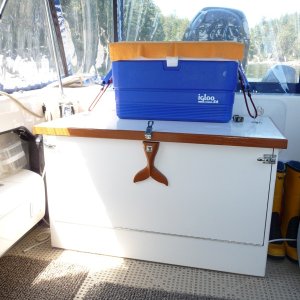 Media '2. Outside perimeter of the box is built out of 3/4" maple plywood. The trim and Humpback Whales Tale is Teak. All hardware stainless steel.
Painted with one exterior primer coat and two marine enamal coats.' in album '1. Cockpit Storage Box. We like to cruise the British Columbia Coast for a month at a time in the summer. With shorter trips throught the year. This box helps to keep our clutter of gear and stuff a little more tolerable, also secure when we leave the boat.'