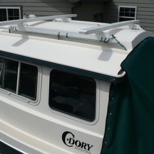 Simple Roof rack for kayaks or whatever. Made from wood and lashed to the rail. Can be removed easyly when time to put the cover on for winter.