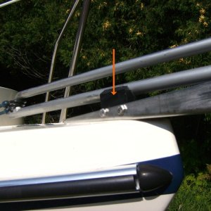 Orange arrow points to the black plastic anchor fastening clip