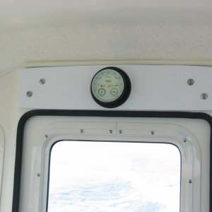 (Not For Hire) Originally wanted barometer on electronics shelf panel next to clock, but wouldn\'t fit. Installed starboard panel over door with longer screws in the factory screw holes and attached barometer with room for future use too.