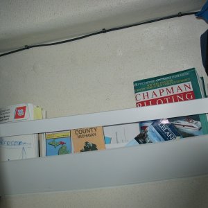 (Not For Hire) Magazine, chart, book rack under table.