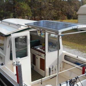 Media 'The cockpit framework is made of 7/8" thickwall SS and can be broken down to 4' sections and stored under the gunnels.' in album 'I used this idea for several years and realized 200 watts was overkill for me.  I remounted one 100 watt panel on standoffs on the middle of the roof.  This clears the hand rails and looks neater.'