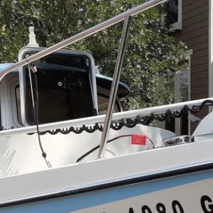 Motorguide long shaft trolling motor at bow is lockable into place and removable for storage.