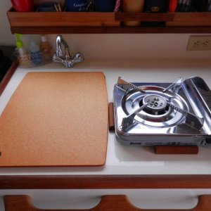 Stove on counter - fits into cleats to hold in place.  Cutting board cleats fit down in sink opening and stays put.  Adds counter space.
