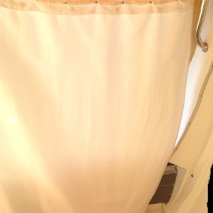 Here, the curtain is drawn toward the port handle grip.  This is used not only for privacy, but also to block the sun when necessary while we sit in the cockpit.