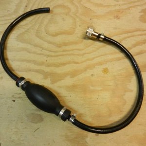 Media 'Then I made up a short hose with a primer bulb on it to pump the gas.' in album 'Fuel port next to outboard cable exit with rubber dust cap'
