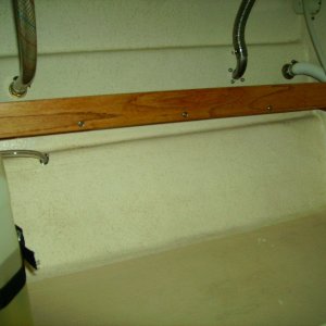 Shelf under sink.  7 1/2" oak with a 2" oak fiddle to keep stuff from sliding off.  Sits behind storage bin baskets, removed for photo.