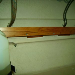 You can see wood glued to hull with 5200 quick set.  Then "L" brackets installed to hold shelf.  Very secure.
