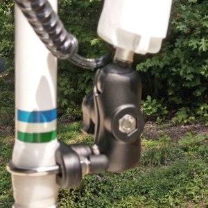 Close up of RAM mount, stainless U bolt, short handle, and ball with threaded shaft to fit threaded insert on bottom of Optronix handheld spotlight (3/8 x 16 thread). RAM also offers the ball with a 1/4 x 20 camera tripod thread) Antenna is wrapped a few wrappings with clear Rescue Tape.