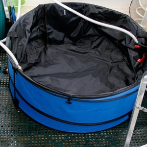 Media 'Hot Tub before filling - Return hose from the heat exchanger is terminated by a hose nozzle or a shower head. The hose nozzle is left open while water is recirculating.' in album 'Heat Exchanger is constructed using 25 ft of 3/8 copper tubing coils. The coils are submerged in a pot of water which is heated on the Wallas. THe water hoses are attached to the coil using quick connect fittings. Hoses are stowed out of sight behind the starboard seat cushion for quick deployment.'