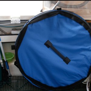 The 36 in. collapsible tub is stowed either against the starboard cockpit gunnel behind a chair or stood up in the motor well. The spring frame tub collapses to a thickness of only 2 inches and sets up quickly using the 4 fiberglass side support rods stowed on the bottom as shown.