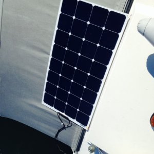 100w flexible panel, zip tied on, weather stripping under panel to prevent chafe, waterproof plug, panel does not flutter, easily removed.
