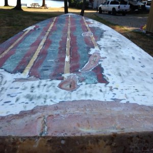 partially stripped bottom paint, angle grinder 50 grit disc.  Transom shows previous bad repair.