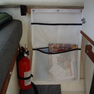 Media 'storage pocket on port wall under table.  Snaps attach pocket to oak strip, glued to wall.' in album 'E)dinette'