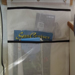 Storage pocket on starboard wall, just forward of captain's chair