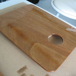 Sink cover board while varnishing.  I made a similar one (sans hole) for the cutout where the Wallas used to be.  It's surprisingly handy to be able to remove it to work on things (wiring etc.) under the galley, although I may eventually replace the whole galley counter and if so will likely make it a solid piece except for the sink cutout.