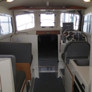 Cabin with table stowed and passenger seats facing forward