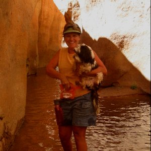 Toni Carrying Baxter in Stream Bed through Slot at Fifty Mile Canyon 9-22-09