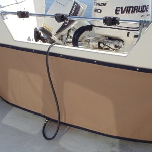 Custom made canvas cover in front of tanks and behind all the wires at the helm. Matches interior pieces.