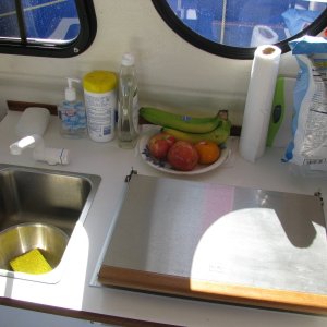 The Galley top is made of laminate.  The Faucet is actually a very high quality Euro-design, with ceramic valves.  The faucet contains a switch that starts the pump and allows for variable water flow.  To the right is the Wallas two-burner diesel stove.  It boils water quickly, and is powerful enough to heat both the cabin and the enclosed cockpit.  Yet it can be set to low speed, and keep everyone in the cabin comfortable.  USE DIESEL FUEL!  Les told us that diesel has more btu's of heat per unit and has a longer shelf life than kerosene (2 years as opposed to 6 months or so.)  And it is a miser on fuel.  We only burned about 1.5 gallons for the three weeks we were on the boat, and we used it to heat the cabin for 2 to 4 hours per day.