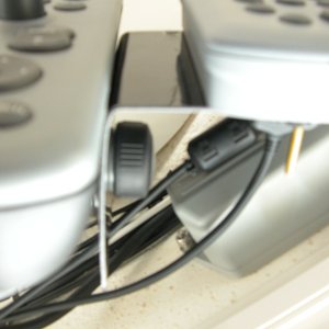 Media 'View from bottom of C80. Note the clearance for original mounting knob used to support the bracket. This also allows the bracket to swing face down to get at the connectors and mounting screws. The brass screws have clean fingernail polish on(all) the threads to keep them from backing out.' in album 'Raymarine Alpha Numeric Keypad monuted to original support bracket.'