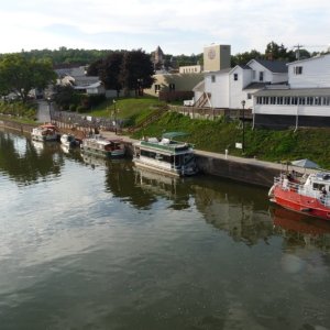 Lyons, NY. Two Bears is the 2nd boat from the left on the lower floating dock. Many small towns on the western end of the canal provide a low floating dock suitable for small boats.  They also often provide power and restroom facilities.  In this case we used the fire hall which is the left end of the white building.  Being an old volunteer fireman, Chuck had a good time visiting with the volunteers that staff the station.