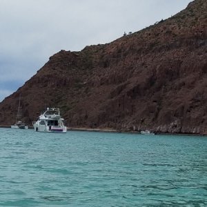 Sierra dwarfed by the other boats and the landscape.