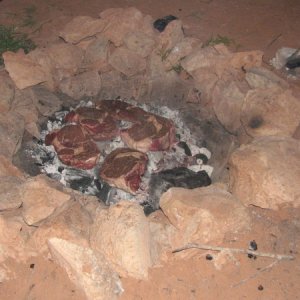 This is primal cooking.  Steaks are thrown directly onto white hot charcoal.  I've never had better steaks.
