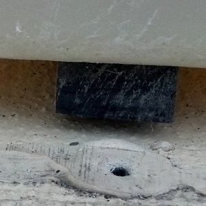 Rubbery strip under fuel tank.