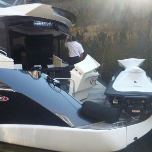 P1020392 The captain was delivering this new boat. I guess he will ride the jet ski home. Not my style but it was a beautiful boat