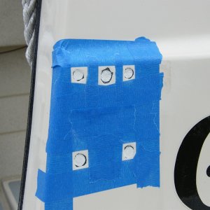Media 'Starboard glasswork ready for gelcoat' in album '11 transom screws or former screws sealed with adhesive sealant were removed, properly filled, and a gelcoat patch kit applied.  Color matching of the kit was definitely off.'