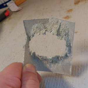The aluminum backing plate was almost gone.  I feared it was because the balsa core was wet enough to start a battery between the stainless steel and the aluminum. I reached up and pulled the backing plate off.  Obviously, it wasn't doing anything other than sprinkling powder into the cockpit.