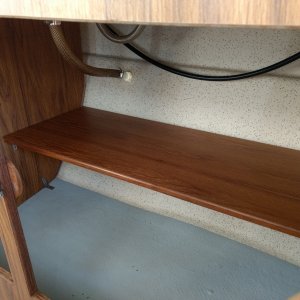 So, a friend of mine had this piece of shelving in his shed and asked me if I wanted it. Initially I said no thanks but then I remembered the C-Dory.

A little cutting and trimming and in it went under the stove/sink. It's just teak veneered partical board so I really expect it'll last all that long but it's better than what was in there (nothing). Besides, can't beat the price.