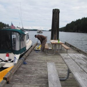 Charlie pumping up kayak on floating dock.
