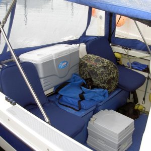 seating in the cockpit. the Honda 2000 generator sits & runs from where shown.  Has worked perfectly through many gallons of fuel from this position.  The blue containers they sit on hold 48 gal of fuel in 8, 6gal jugs. The chest rides there without ice.