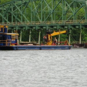 Canal workers removing logs