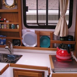 Added plate, bowl, mug storage, rails for spice rack. Hot pad under kettle is also non-skid.