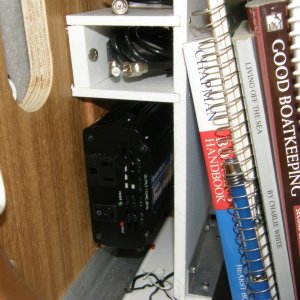 In glove box, hard wired inverter forlaptop that rests on lid; storage for cables and books