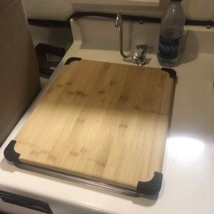 (16" x 14")Cutting board to cover sink, fit perfectly and comes with rubber feet so it doesn't slip.  Cost $19.00