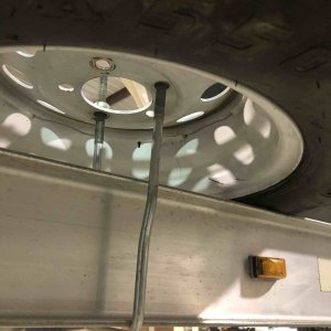 Simple U Bolt holding spare tire to trailer frame.