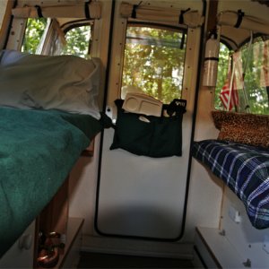 Port and Starboard Beds looking aft. The kitchen storage pocket is removed from the helm seat back and snapped to the cabin door when the starboard bed is setup.