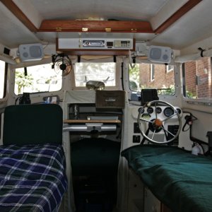 Media 'Port and starboard beds looking forward. My bride sometimes likes to use the port bed as a sofa sometimes looking forward and sometimes with the copilot seat full against the bulkhead looking aft.' in album 'Port and Starboard Beds looking aft. The kitchen storage pocket is removed from the helm seat back and snapped to the cabin door when the starboard bed is setup.'