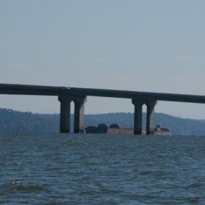 A barge moored just up river of the bridge.
