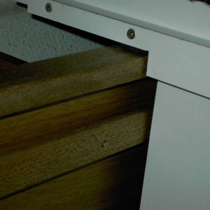 Aft end of forward seat. Slot in mahogany is slide for poly T shaped piece that is fastened onto sliding seat box. Mahogany is bin.