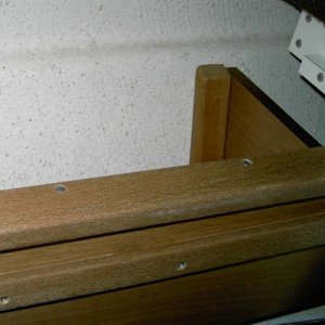 Side bin with slot. Bin runs under gunnel between aft seat front and forward bulkhead. Seat T bar runs back and forth in track.