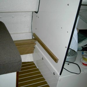 Media 'Seat moved aft. Wooden bumper installed on bulkhead keeps seat box from rubbing on bolt heads below. Bin front end is in center of photo.' in album '533564-R1-10A.jpg'